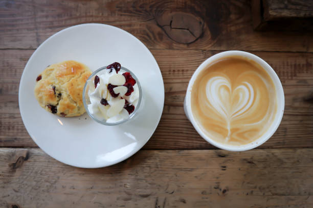 istock hot cofffee, cappuccino coffee and scone , scone with whipped cream 1322144139
