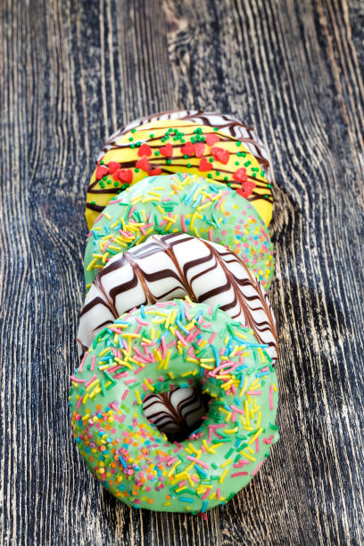 several types of fresh doughnuts covered with chocolate