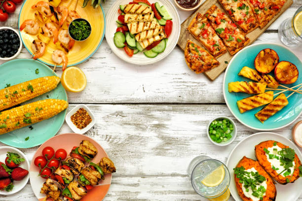 istock Summer BBQ grill frame over a white wood background. Top down view with copy space. 1322149821