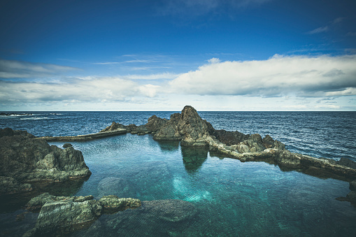 beautiful natural lava rock swimming pools in porto moniz, madeira ilsand, portugal.