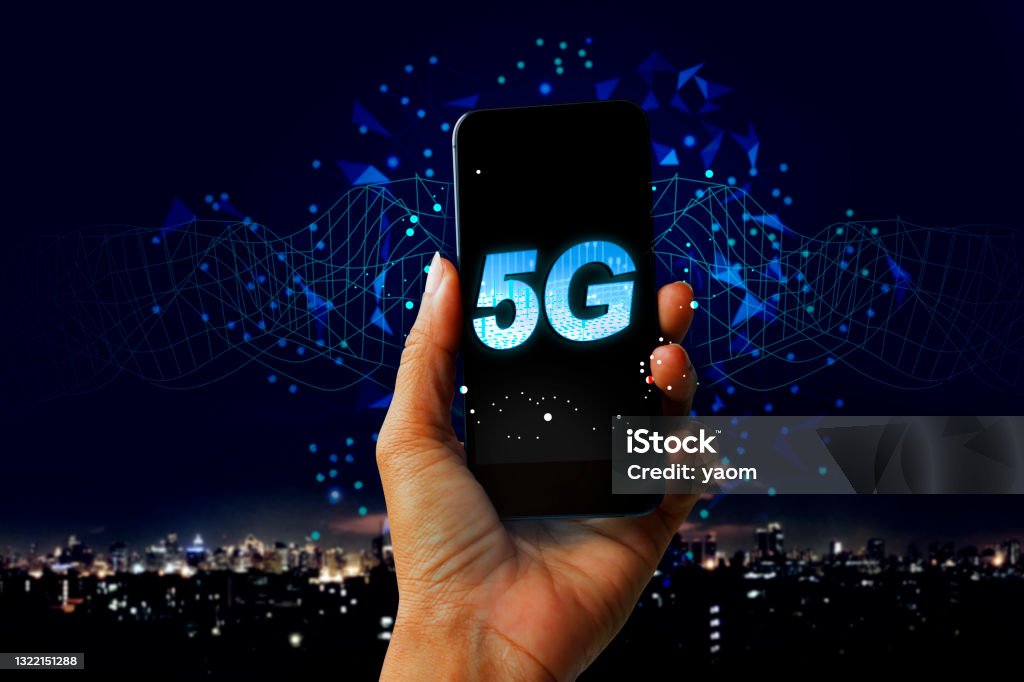 5G network digital hologram and internet of things on city background - Hand holding mobile phone concept of future technology 5G network Connection, Computer Network, 5G, City 5G Stock Photo