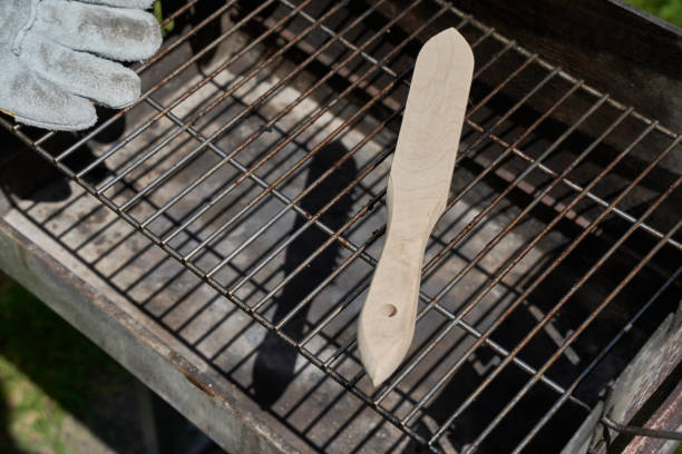 istock Wire brush and protective glove lying on dirty grill rust. Tool casts dark shadow. Oblique from above. 1322151373