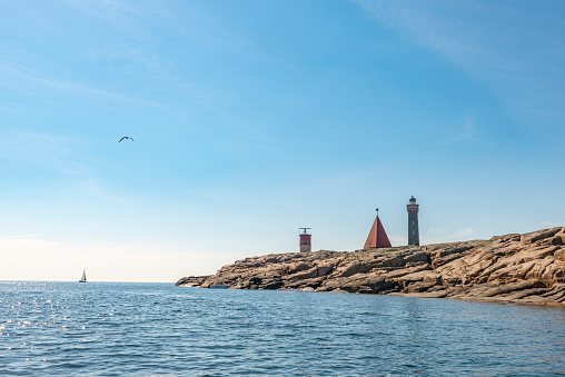 Red canoe moored on the rock beach in Boston, Massachusetts, a tranquil seascape in New England, USA