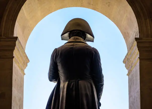 Rear view of the statue of Napoleon Bonaparte by french sculptor Charles Emile Seurre on the balcony of the court of honor of the Hotel des Invalides in Paris, France.