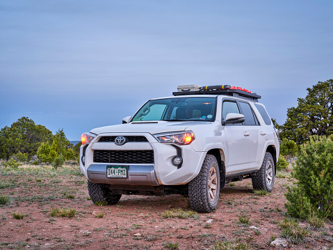 Dinosaur National Monument, CO, USA - May 18, 2021: Toyota 4Runner SUV (2016 Trail model) at dawn in arid landscape of north western Colorado along Yampa Bench Road, springtime morning scenery.