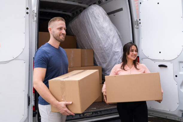 istock Couple Moving Boxes From Van Or Truck 1322156332