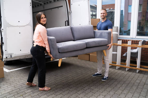 istock Couple Moving Couch Or Sofa Together 1322156423