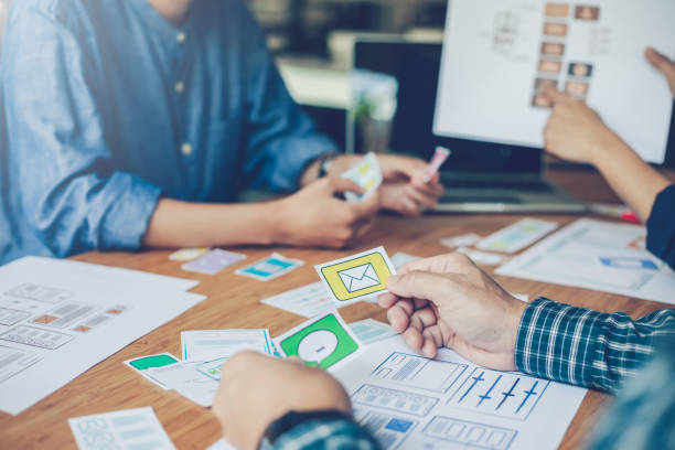 istock Team of website designers who are creative and planning to develop an application on the mobile phone in the office. 1322157959