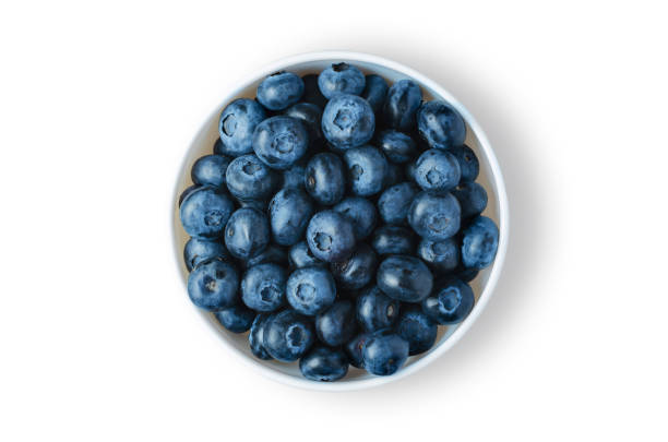 istock Blueberries. Ripe berries in a white plate. Isolated on white 1322159216
