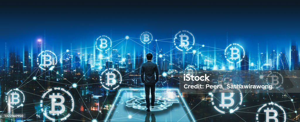 Business man with crypto currency bitcoin on network city technology background Crypto currency bitcoin and digital network concept, Professional business man walking on future smart city background at night in Bangkok, Thailand, Panorama view Cryptocurrency Stock Photo