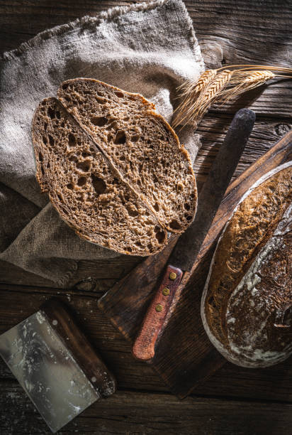 istock Sourdough bread loaf and Banneton basket in bakery on wooden rustic table 1322161446