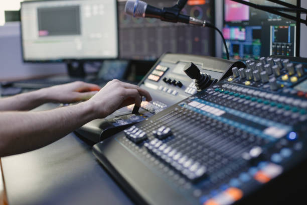 Close up of sound engineer hands recording music stock photo