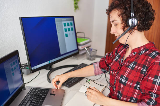 istock Woman connecting a headset to a laptop 1322162250