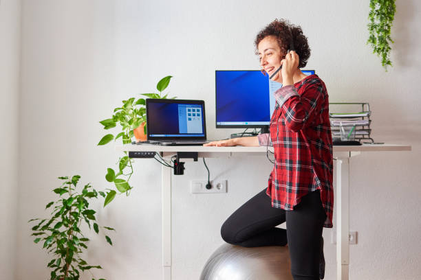 Woman telecommuting at an adjustable standing desk