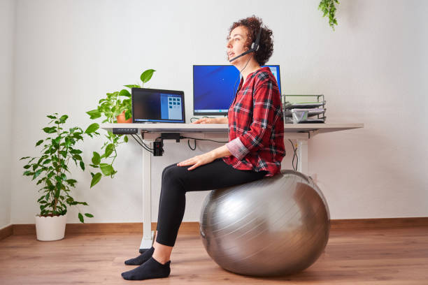 istock Woman teleworking sitting on a fitball 1322162436
