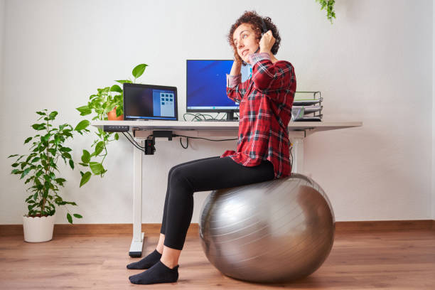 istock Woman teleworking sitting on a fitball 1322162493