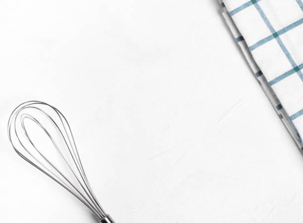 istock Whisk and kitchen towel on the white table 1322163219