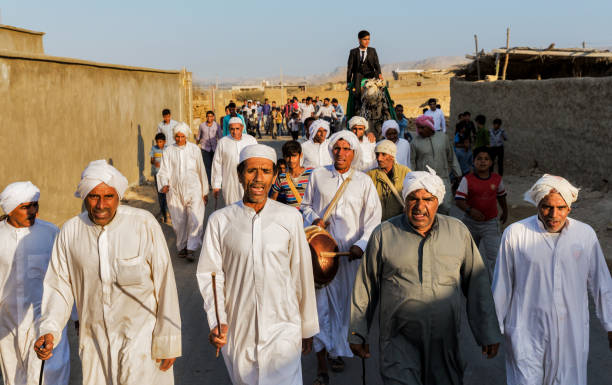 QESHM ISLAND, IRAN - FEBRUARY 05, 2012:  Groom riding a camel during his traditional wedding ceremony in north of Qeshm Island, Hormozgan Province of Iran.