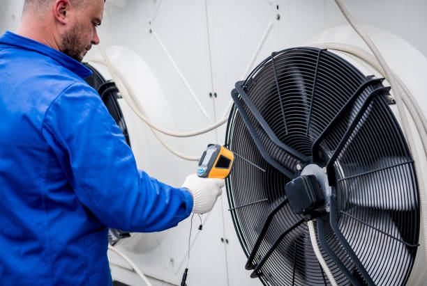 istock Technician uses a thermal imaging infrared thermometer to check the condensing unit heat exchanger. 1322163539