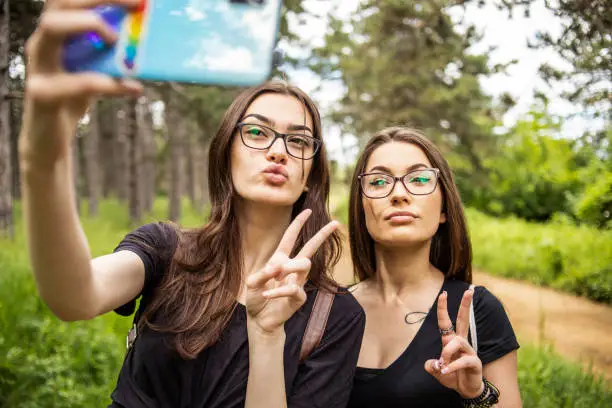 LGBT lesbian couple spending time in nature, using a beautiful day for a walk together and moments of happiness.