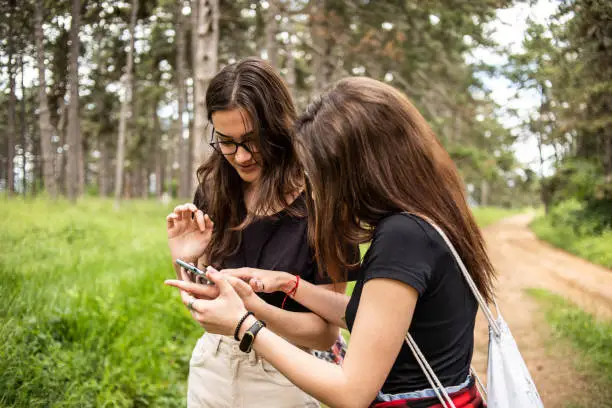 LGBT lesbian couple spending time in nature, using a beautiful day for a walk together and moments of happiness.