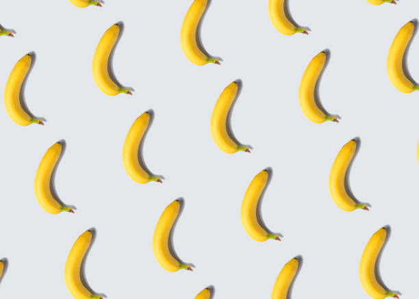 Banana fruit pattern on gray background Single banana fruit pattern on light gray minimal background penis photos stock pictures, royalty-free photos & images