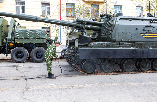 Samara, Russia - May 6, 2017: Soldier paints a self-propelled 152 mm howitzer Msta-S (NATO name - M1990 Farm) before the parade