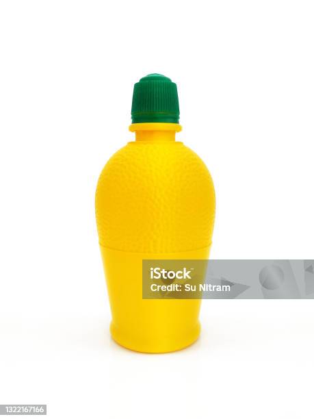 Close Up Of Bottle Of Squeezed Lemon Juice Dressing Lemon Juice In An Open Bottle On A White Background Yellow Plastic Container And Green Cap Plastic Bottle Of Lemon Juice To The Sauce Isolated Stock Photo - Download Image Now