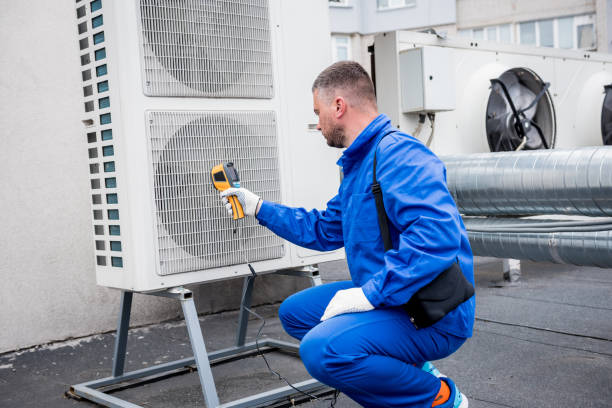 istock Technician uses a thermal imaging infrared thermometer to check the condensing unit heat exchanger. 1322168250