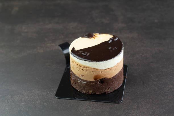 istock Tasty mini three chocolates cake on a dark background 1322171777