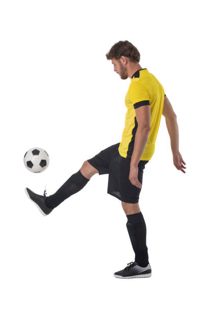 istock Soccer player kick ball 1322175168