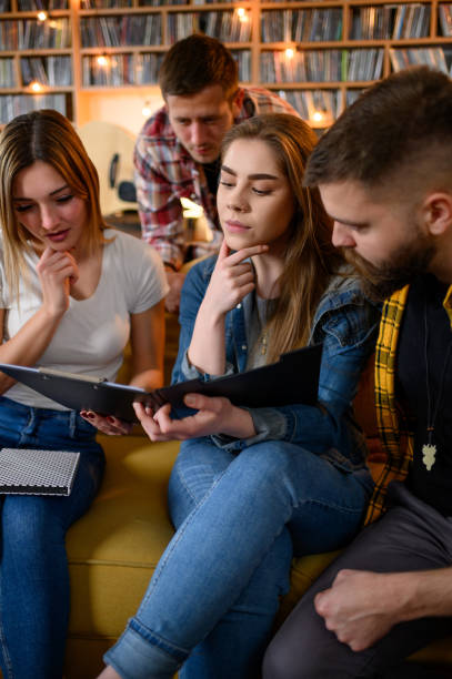 istock A group of young students studying for their exam together at home 1322180014