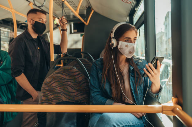 istock Young passengers in the bus wearing protective mask and using smartphone 1322180020