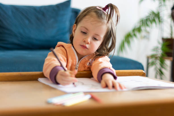 istock Girl drawing at home 1322181060