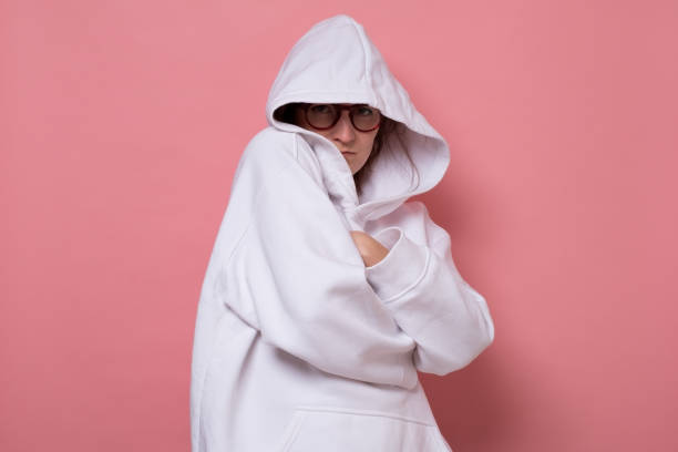 istock Young woman scared, afraid and anxious, hiding face, looking at camera 1322182194