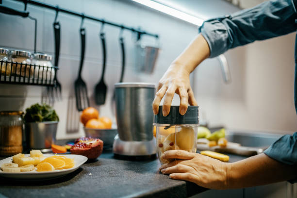 istock Woman blending fruit in the kitchen 1322182507