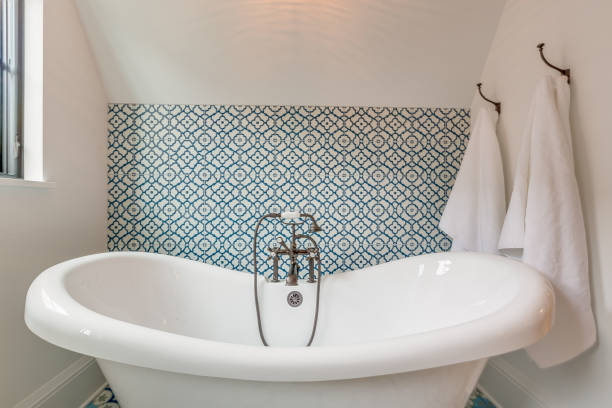 istock Large freestanding bathtub with handheld faucet 1322183654
