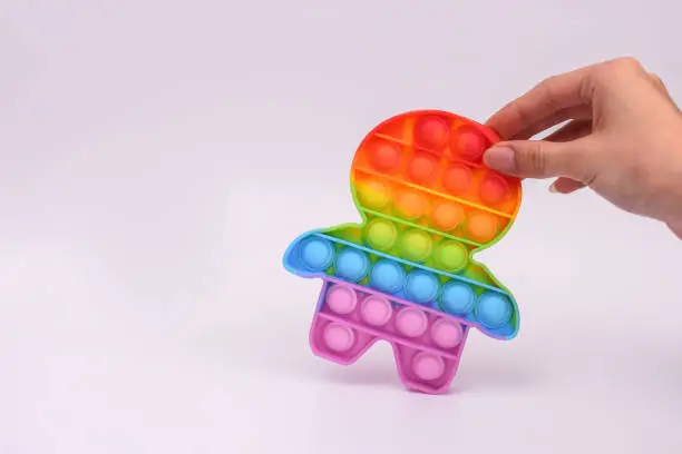Photo of pop it toy. color anti-stress toy. empty space