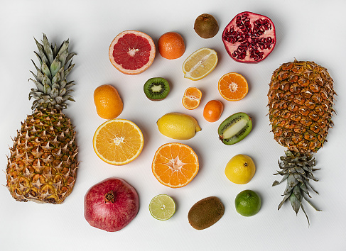 vitamin set with tropical fruits on a light background. Healthy eating and antioxidant diet concept