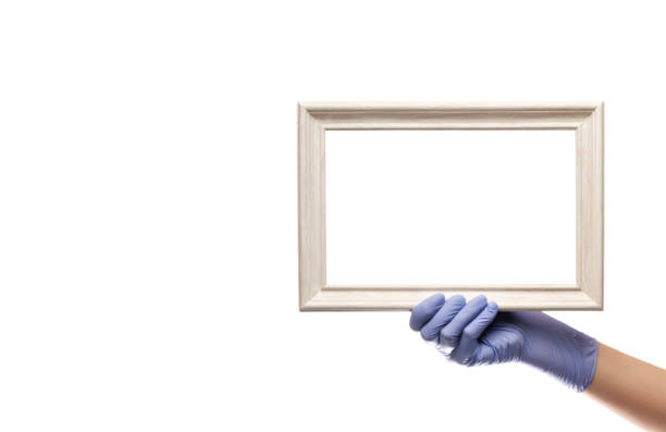 istock Picture frame in hand, hand in latex glove. 1322185834