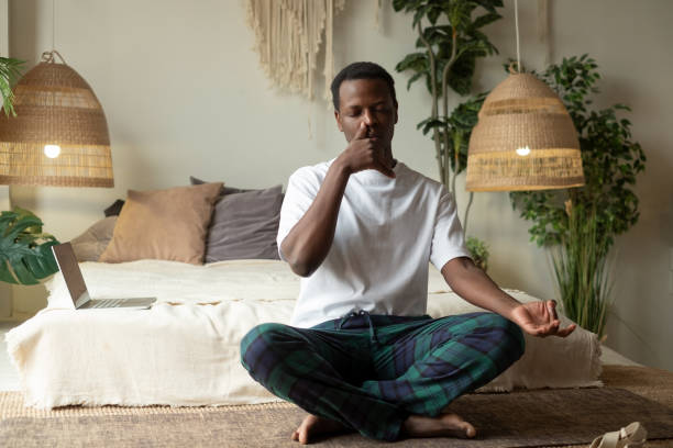 istock Young african man practicing yoga lesson, doing Alternate Nostril Breathing exercise 1322189243