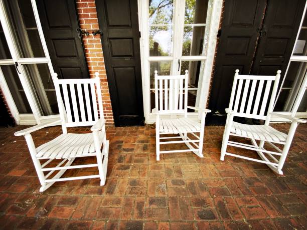 istock 3 White Rocking Chairs on a Porch 1322192368