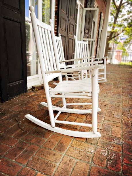 istock 3 White Rocking Chairs on a Porch 1322192371