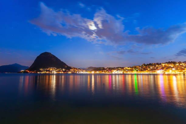 Lugano lake and city, Switzerland Lugano lake and Lugano city panoramic view in canton of Ticino in Switzerland at night lugano stock pictures, royalty-free photos & images