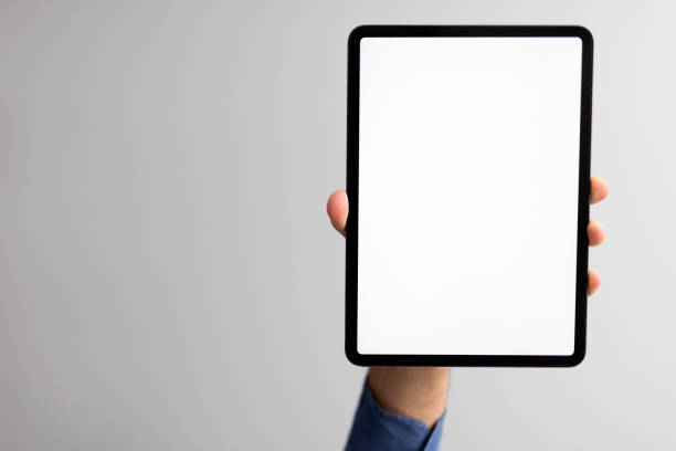 istock A man holding black tablet pc with blank white screen in the outdoors street background 1322200402