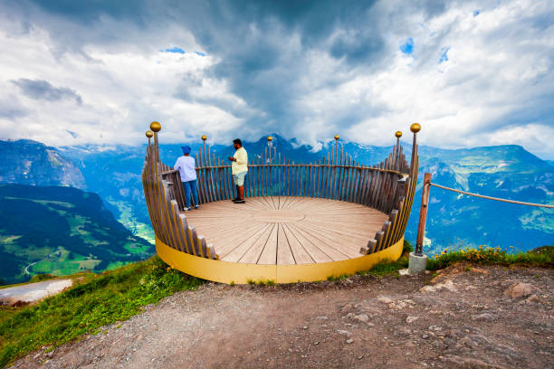 WENGEN, SWITZERLAND - JULY 14, 2019: Unidentified tourists at the Mannlichen viewpoint near the Wengen town in the Lauterbrunnen valley in Switzerland