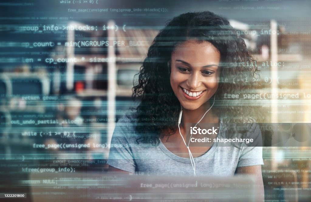 Digitally enhanced shot of an attractive businesswoman using a laptop superimposed over multiple lines of computer code The wifi is helping me to finish this project faster Coding Stock Photo