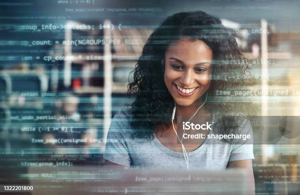 Digitally Enhanced Shot Of An Attractive Businesswoman Using A Laptop Superimposed Over Multiple Lines Of Computer Code Stock Photo - Download Image Now