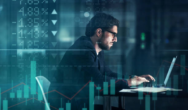 Digitally enhanced shot of a handsome businessman using a laptop superimposed over a graph showing the ups and downs of the stock market Tonight its all about hard work digital price stock pictures, royalty-free photos & images