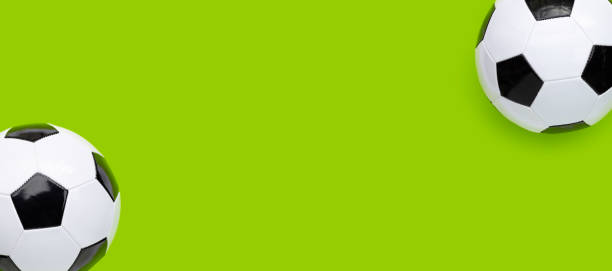 istock Soccer balls on green background. Top view 1322205537
